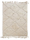 Tapis berbère Beni Ouarain en laine naturelle, tissé à la main au Maroc. Motifs en relief, douceur épaisse et charme artisanal. Pièce unique et chaleureuse.